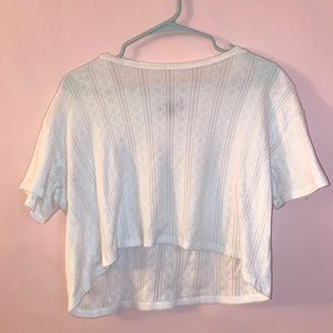 Cropped white shirt with a subtle design.